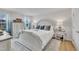 Spacious bedroom with large white furniture set and wood floors features a view to the outdoors at 48 Highview Ct, Fuquay Varina, NC 27526