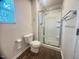 Modern bathroom featuring a glass-enclosed shower with built-in shelves and stylish fixtures at 50 Teal Dr, Youngsville, NC 27596