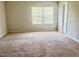 Bright bedroom featuring a large window and neutral carpet at 50 Teal Dr, Youngsville, NC 27596