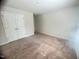 Spacious bedroom featuring neutral carpet and a double door closet at 50 Teal Dr, Youngsville, NC 27596