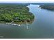 Breathtaking aerial view of waterfront property with private boat docks nestled amidst lush greenery at 52 Buoy Dr, Henderson, NC 27537