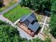 Scenic aerial shot of log home with a spacious yard and wooded surroundings at 52 Buoy Dr, Henderson, NC 27537