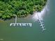 Aerial view of docks filled with boats along a scenic shoreline in a lake community at 52 Buoy Dr, Henderson, NC 27537