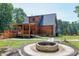 Log cabin home featuring a fire pit, covered porch, walkway, and landscaped yard at 52 Buoy Dr, Henderson, NC 27537