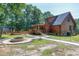 Log cabin with outdoor fire pit and scenic yard, including pathways and storage building at 52 Buoy Dr, Henderson, NC 27537