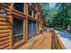 Stunning log home deck with beautiful wood, large windows, and lovely outdoor seating at 52 Buoy Dr, Henderson, NC 27537