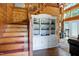 Inviting entryway with wooden staircase, stylish china cabinet, and hardwood flooring, perfect for welcoming guests at 52 Buoy Dr, Henderson, NC 27537