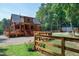 Charming log cabin home with a spacious deck, fenced yard, and peaceful wooded setting at 52 Buoy Dr, Henderson, NC 27537