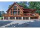 Log cabin with expansive porch and lattice foundation, nestled in a wooded setting at 52 Buoy Dr, Henderson, NC 27537