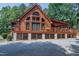Charming log cabin home featuring a spacious deck, lattice work and ample parking nestled in a wooded setting at 52 Buoy Dr, Henderson, NC 27537