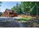 Beautiful log cabin home with a large deck, stone pathway, and fenced yard at 52 Buoy Dr, Henderson, NC 27537