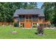 Charming log cabin with a screened porch, wooden deck, and beautifully landscaped front yard at 52 Buoy Dr, Henderson, NC 27537