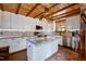 A modern kitchen island with granite countertops and stylish lighting fixtures against wood paneled walls at 52 Buoy Dr, Henderson, NC 27537