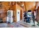 Charming living room showcasing wooden architecture, rustic decor, and seamless flow to dining area at 52 Buoy Dr, Henderson, NC 27537
