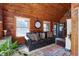 Cozy living room with comfortable leather sofa, rustic decor, and natural light creating a warm and inviting atmosphere at 52 Buoy Dr, Henderson, NC 27537