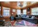Cozy living room with wood paneled walls, a comfortable sectional sofa, and a decorative rug at 52 Buoy Dr, Henderson, NC 27537
