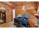 Cozy wooden office space featuring a blue desk with dual monitors and ample natural light at 52 Buoy Dr, Henderson, NC 27537