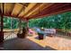 Outdoor porch with comfortable seating, a hammock, and views of the surrounding greenery at 52 Buoy Dr, Henderson, NC 27537