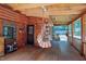 Inviting log cabin porch featuring a swing, wooden floors, and charming rustic details at 52 Buoy Dr, Henderson, NC 27537