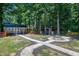 Wooded lot with storage shed, fire pit, and log cabin home at 52 Buoy Dr, Henderson, NC 27537