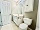 Clean and compact bathroom with white vanity, toilet, medicine cabinet and fixtures at 5419 Vista View Ct, Raleigh, NC 27612