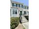 Charming townhouse exterior featuring green shutters, a well-manicured lawn, and concrete stairs to the front door at 5419 Vista View Ct, Raleigh, NC 27612