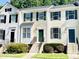 Charming townhouse with a well-maintained lawn, green shutters, and concrete stairs leading to a green front door at 5419 Vista View Ct, Raleigh, NC 27612