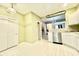 Well-lit kitchen featuring white cabinets, white flooring and stainless steel appliances at 5419 Vista View Ct, Raleigh, NC 27612