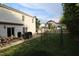 Scenic backyard highlighting a patio, grill, manicured lawn, and decorative accents with natural surroundings at 5456 Thunderidge Dr, Raleigh, NC 27610