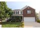 Two-story home with brick and siding, complemented by a well-manicured lawn and vibrant, mature landscaping at 5456 Thunderidge Dr, Raleigh, NC 27610