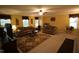 Living room featuring carpet and multiple windows, comfortable seating, and a ceiling fan at 5456 Thunderidge Dr, Raleigh, NC 27610