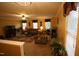 Bright living room featuring neutral carpet, multiple windows, comfortable seating, and a ceiling fan at 5456 Thunderidge Dr, Raleigh, NC 27610