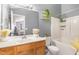 Bathroom featuring a stylish vanity, toilet, bathtub, and a large mirror at 5849 Ricker Rd, Raleigh, NC 27610
