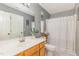 Bathroom featuring a stylish vanity, a large mirror and a shower with white curtain at 5849 Ricker Rd, Raleigh, NC 27610
