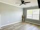Bright bedroom with neutral walls, wood-look flooring, and large windows at 5849 Ricker Rd, Raleigh, NC 27610