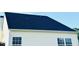 Exterior view of a home with yellow siding and black roof at 5849 Ricker Rd, Raleigh, NC 27610