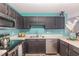 Stylish kitchen with stainless steel appliances, dark cabinets, and countertop at 5849 Ricker Rd, Raleigh, NC 27610