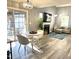 Bright living room with stylish seating, a modern fireplace, and sliding glass doors to outdoor patio at 5849 Ricker Rd, Raleigh, NC 27610