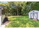 The backyard features a shed, well-manicured landscaping, and mature trees offering a private outdoor space at 709 Brighton Rd, Raleigh, NC 27610