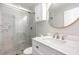 Elegant bathroom with a marble shower, gold circular mirror, and white marble vanity at 709 Brighton Rd, Raleigh, NC 27610