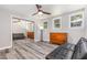 Bedroom with large mirrored closet, ceiling fan, dresser, futon, grey floors and natural light from windows at 709 Brighton Rd, Raleigh, NC 27610