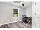 Neutral toned bedroom features a ceiling fan, desk and chair, and a window for natural light at 709 Brighton Rd, Raleigh, NC 27610