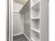 This is a view of a walk-in closet featuring wooden shelves and a rack for hanging clothes at 709 Brighton Rd, Raleigh, NC 27610