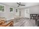 Dining room with ceiling fan, grey floors, and glass top table with seating and view of entry door at 709 Brighton Rd, Raleigh, NC 27610