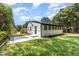 Exterior view of the house and backyard featuring a small patio, wooden fencing, and lush lawn at 709 Brighton Rd, Raleigh, NC 27610