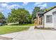 A well manicured lawn and white brick house with light wood features at 709 Brighton Rd, Raleigh, NC 27610
