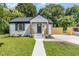 Charming home with white brick, inviting porch, and lush green lawn at 709 Brighton Rd, Raleigh, NC 27610