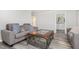 Inviting living room showcasing gray sofas, and views of the kitchen at 709 Brighton Rd, Raleigh, NC 27610