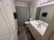 Neutral bathroom featuring a vanity with storage and a shower with patterned curtain at 7194 Johns Point Ct, Liberty, NC 27298