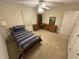 This bedroom features a twin bed, a ceiling fan, and a corner desk with drawers for ample storage at 7194 Johns Point Ct, Liberty, NC 27298
